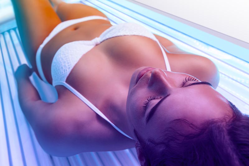 Woman tanning on sunbed