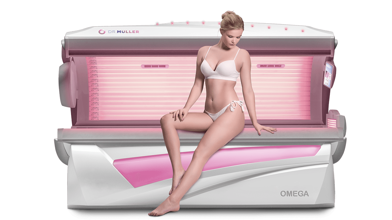 Woman sitting on top of a pink sunbed